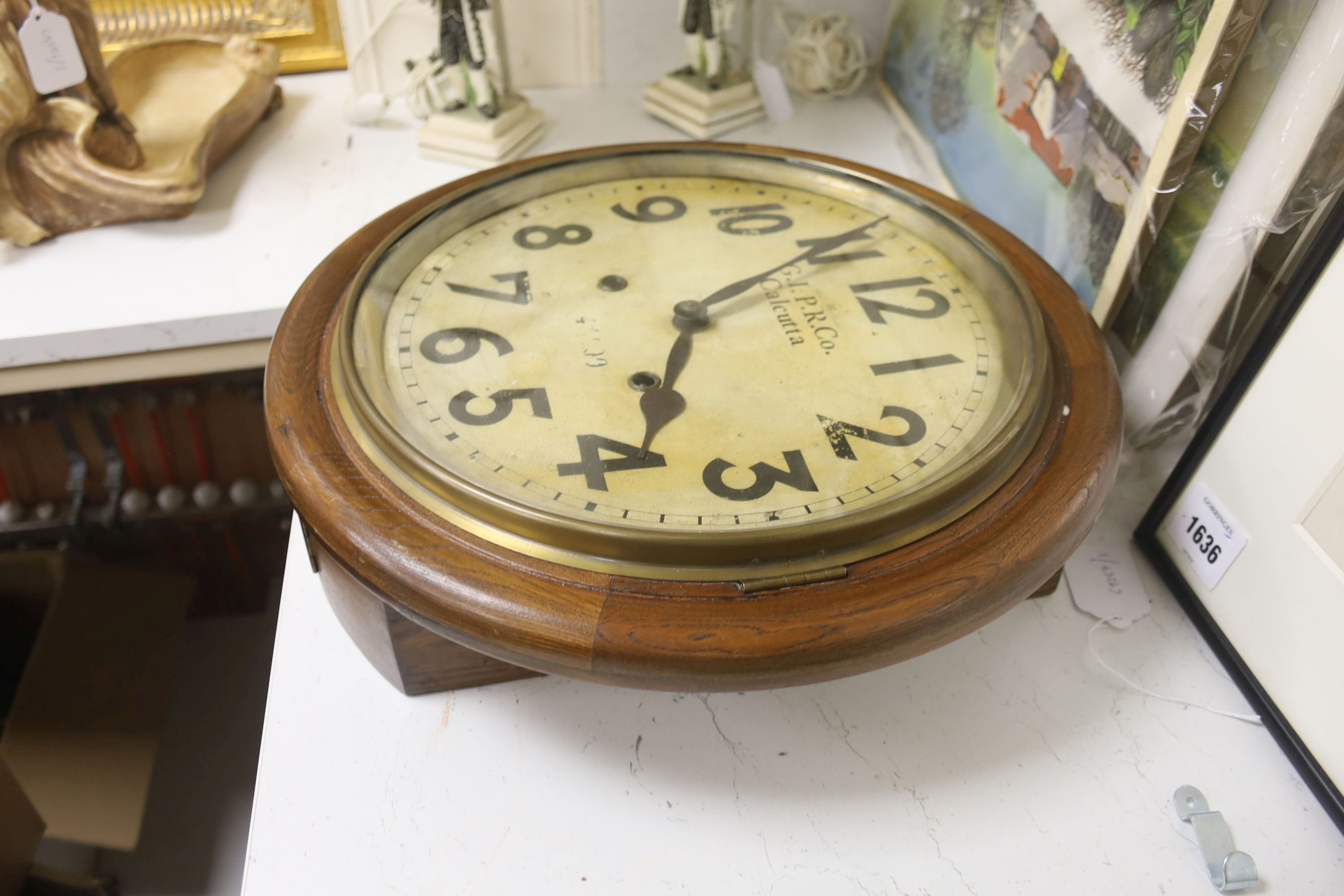 An early 20th century oak wall dial clock marked GIPR CO Calcutta, diameter 39cm
